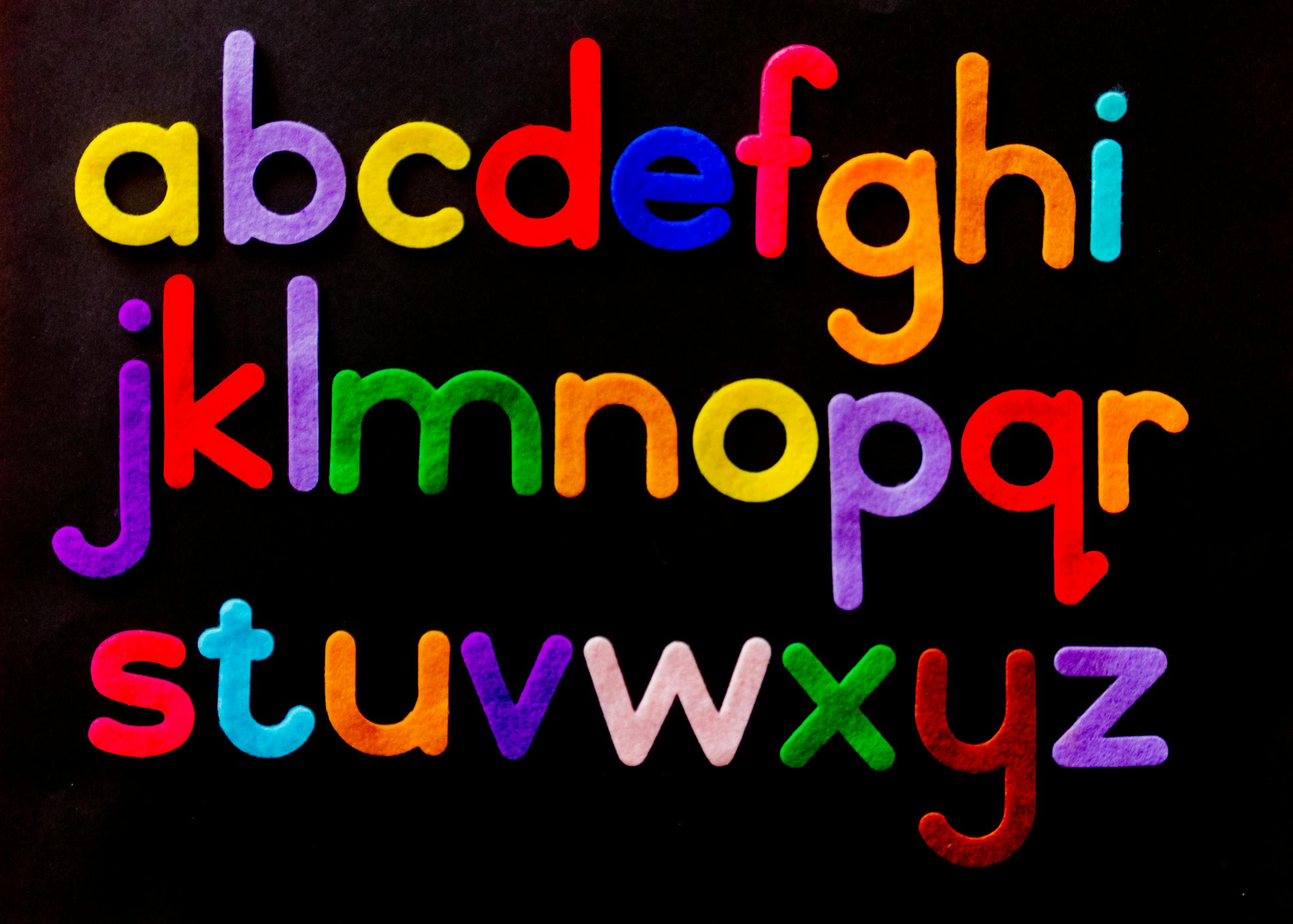 Vibrant alphabet letters arranged against a dark background for educational use.